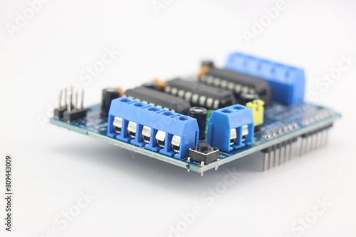 Motor driver or servo shield with a close up view of connection pins on a white background