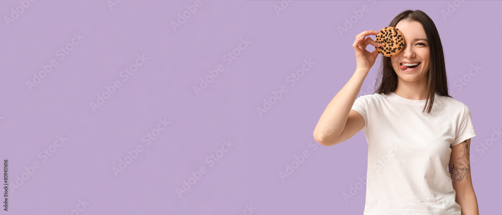 Funny young woman with tasty cookie on lilac background Funny young woman with tasty cookie on lilac background