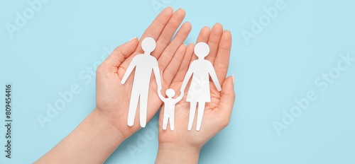 Woman holding human figures...