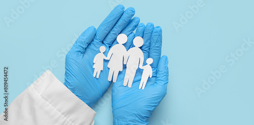 Doctor holding family figur...