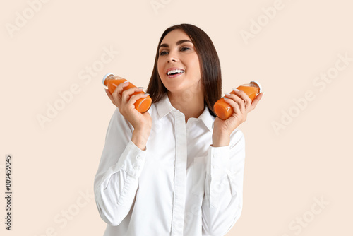 Young woman with bottles of...