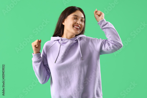 Joyful young asian woman da...