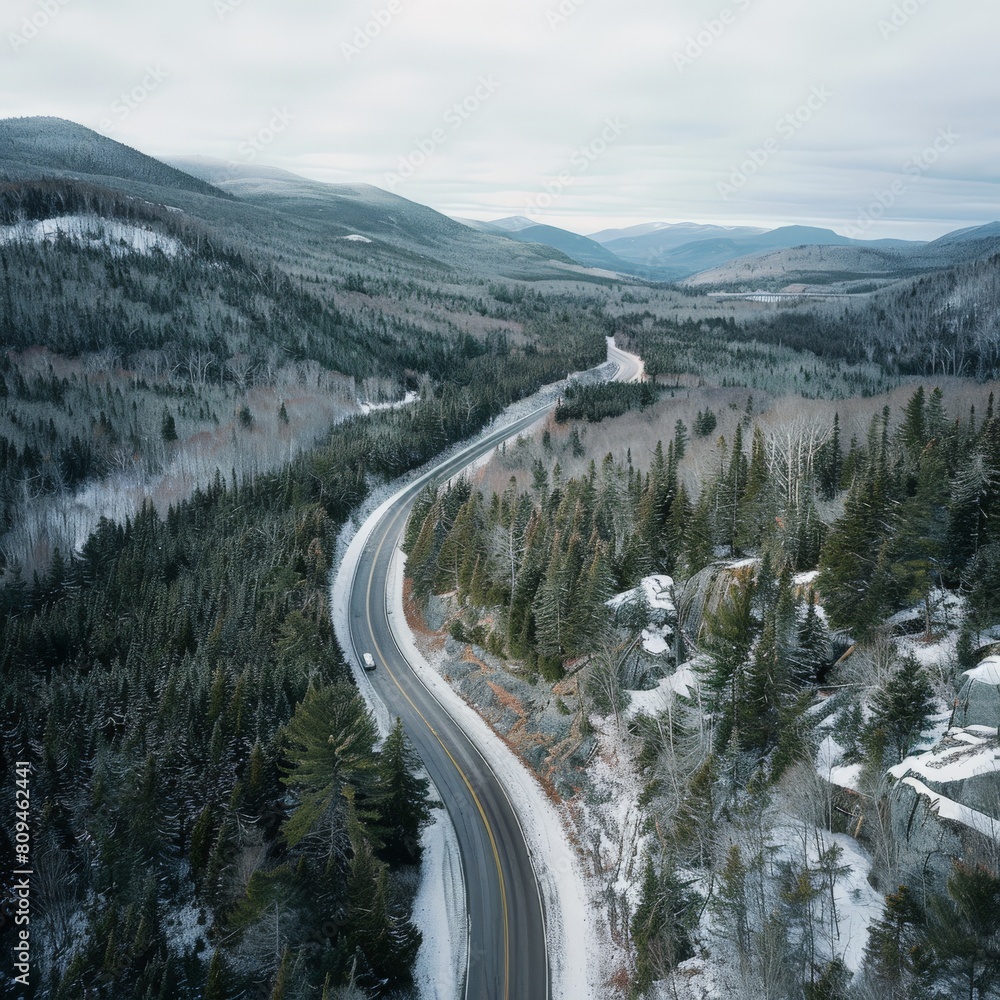 Aerial View of a Mountain Road Cutting Through a Forest Aerial View of a Mountain Road Cutting Through a Forest