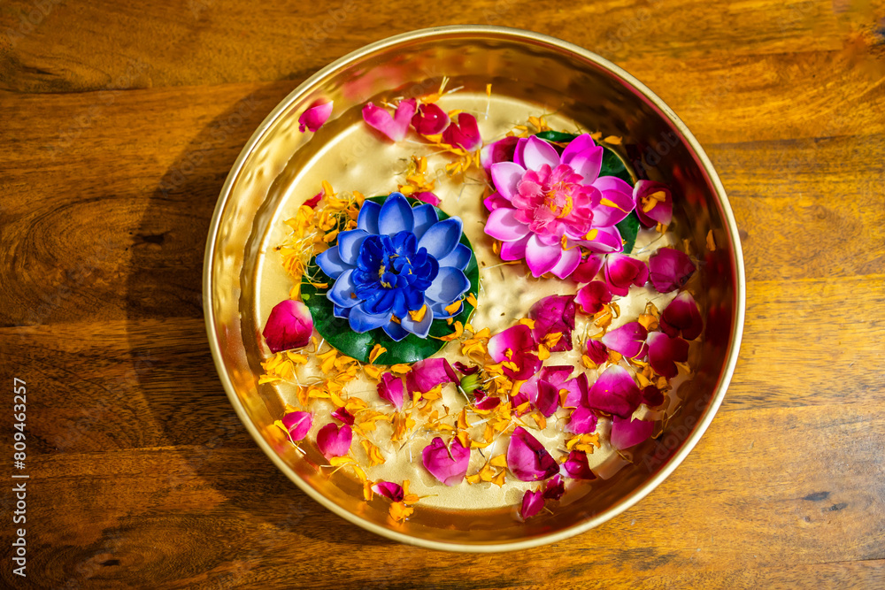 decorated flowers kept in copper plat at festival at home form top angle decorated flowers kept in copper plat at festival at home form top angle