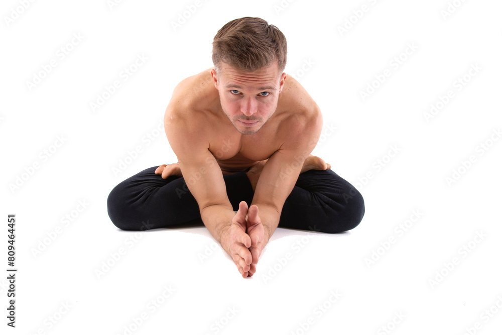Sports and healthy lifestyle. An attractive man is doing Pilates. White background. Sports and healthy lifestyle. An attractive man is doing Pilates. White background.
