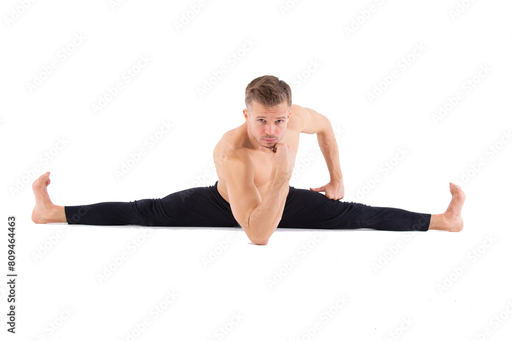 Sports and healthy lifestyle. An attractive man is doing Pilates. White background. Sports and healthy lifestyle. An attractive man is doing Pilates. White background.