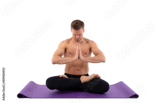 Sports and healthy lifestyle. An attractive man is doing Pilates. White background.