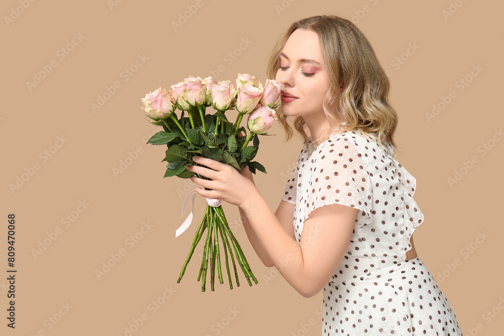 Young woman with bouquet of beautiful roses on brown background Young woman with bouquet of beautiful roses on brown background