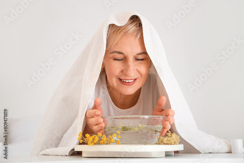 Mature woman with towel doi...