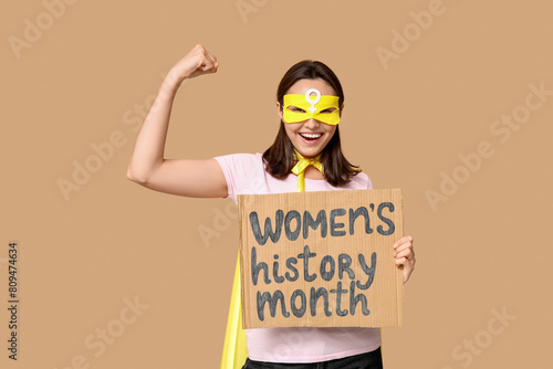 Young woman in superhero co...