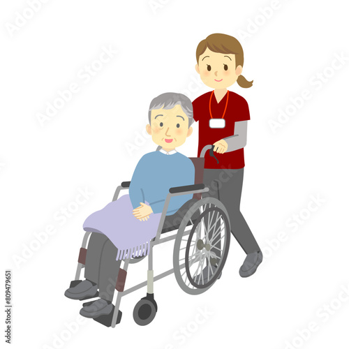 訪問看護スタッフが車いすに乗ったおじいさんを介助する様子（介護、看護、デイサービス若い女性）
