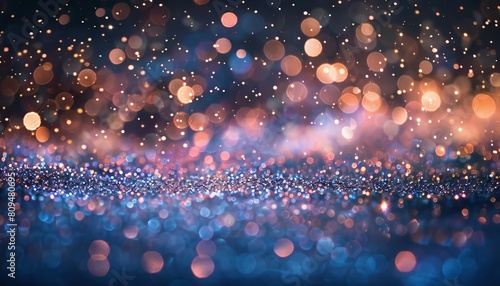 An abstract composition where glitter particles produce shimmering bokeh against a black background photo