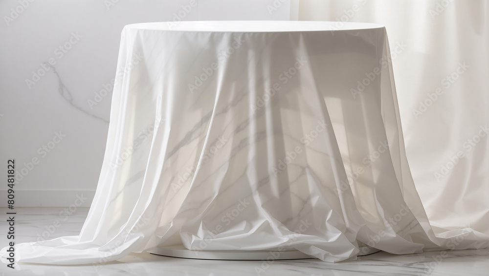A round table is covered with a white cloth.

