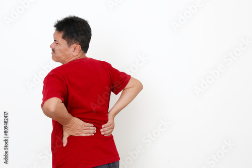 Back view of a guy suffering from a backache photo