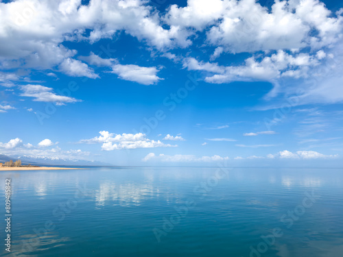 Sunny summer day on the lake. Mountains and sea. Kyrgyzstan, Lake Issyk-Kul photo