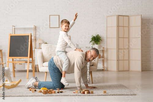 Grandfather with his cute l...