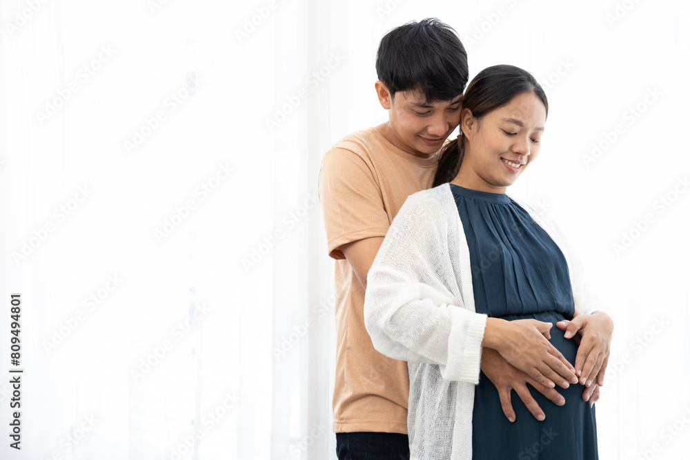 happy couple hands touching and hugging pregnant belly and making their hands in heart shape happy couple hands touching and hugging pregnant belly and making their hands in heart shape