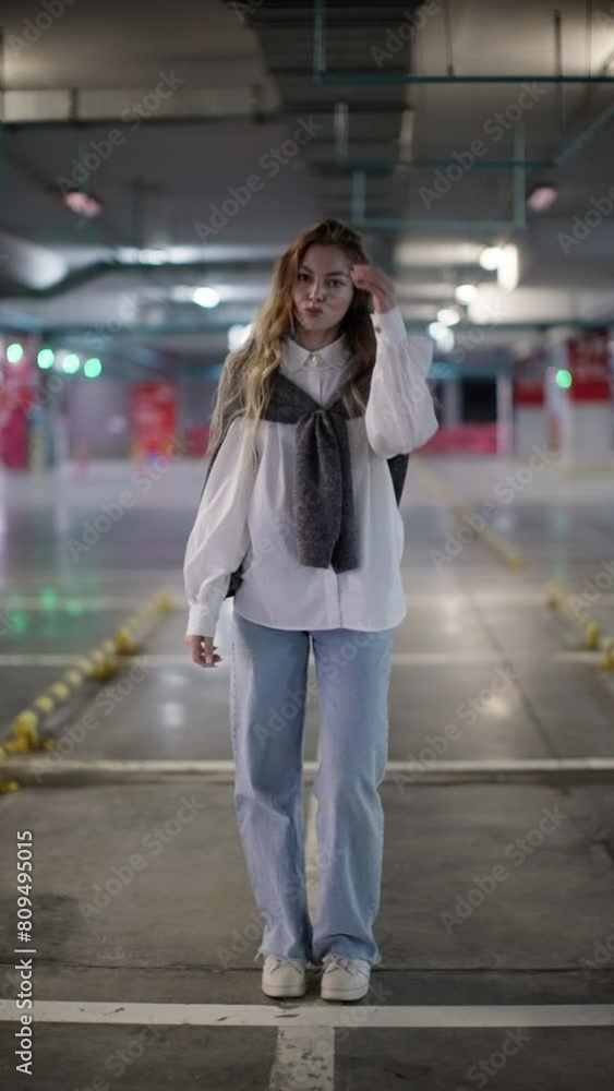 Young woman standing confidently in parking garage, urban chic style with soft lighting Young woman standing confidently in parking garage, urban chic style with soft lighting