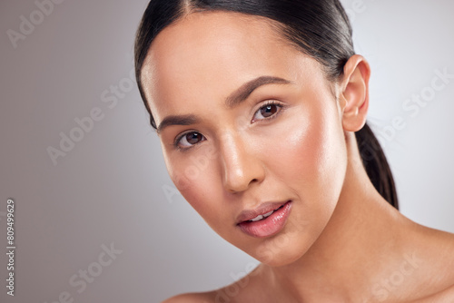 Beauty, glowing and portrait with natural woman closeup in studio on gray background for wellness. Aesthetic, face and skincare with serious model at spa for cosmetics or dermatology treatment