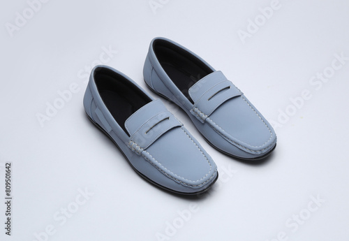 light blue leather loafers slip on shoes isolated on grey background