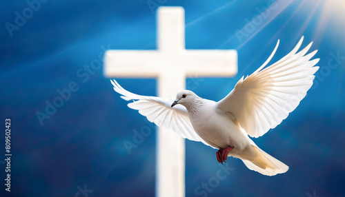 Flying white pigeon in front of a crucifix. Pentecost concept.