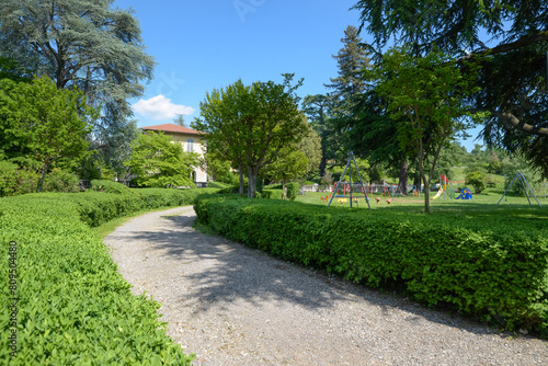 Public park with children's play area. Tradate city, Italy. Park of Villa Inzoli in summer. In the park there is an educational farm and an educational vegetable garden