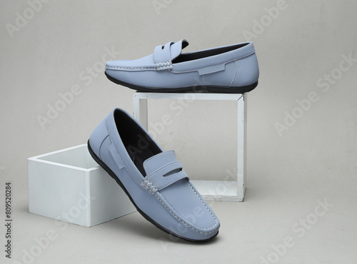 light blue leather loafers slip on shoes isolated on grey background