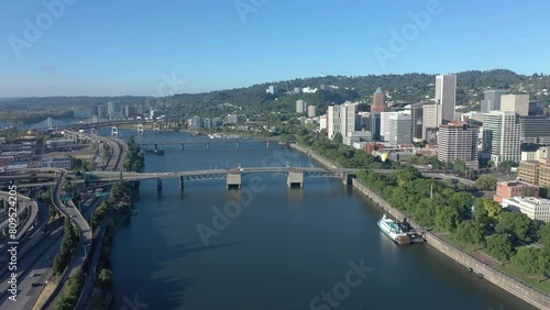 Portland Oregon, drone flying backwards over Willamette River revealing bridge. photo