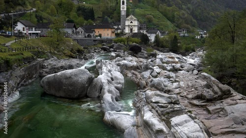 Church in Lavertezzo, Verzasca. Filmed from the bridge. The picture pans from the stream up to the church. You can see the wonderful green color of the crystal clear river photo