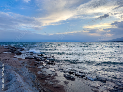 Sunny summer day on the lake. Mountains and sea. Kyrgyzstan  Lake Issyk-Kul