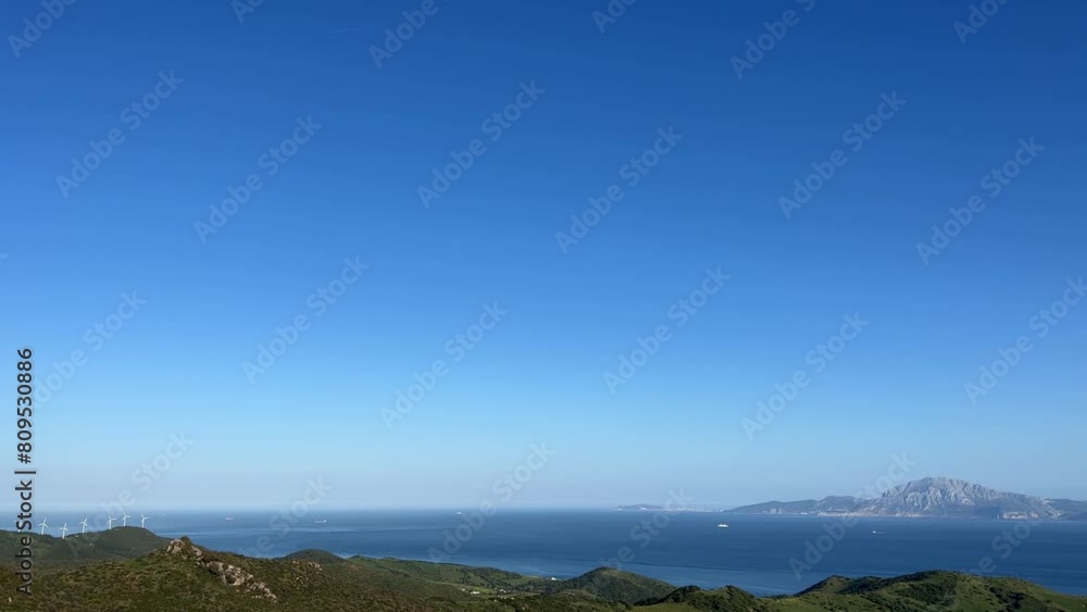 breathtaking panoramic view of Gibraltar on a sunny day. The camera pans slowly across the horizon, taking in the impressive landscape. In the distance, in the sparkling blue of the sea, you can see s breathtaking panoramic view of Gibraltar on a sunny day. The camera pans slowly across the horizon, taking in the impressive landscape. In the distance, in the sparkling blue of the sea, you can see s