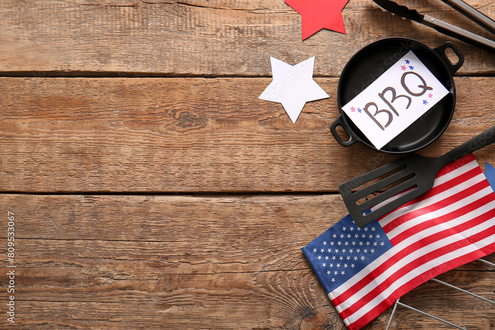 Obraz premium Composition with barbecue utensils and flag of USA for Independence Day celebration on wooden background