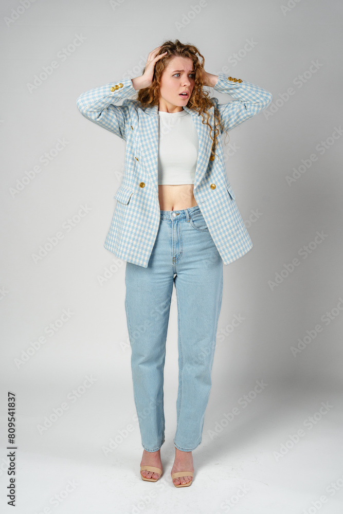 Young Businesswoman Gesturing Excitement or Surprise Against a Neutral Background Young Businesswoman Gesturing Excitement or Surprise Against a Neutral Background
