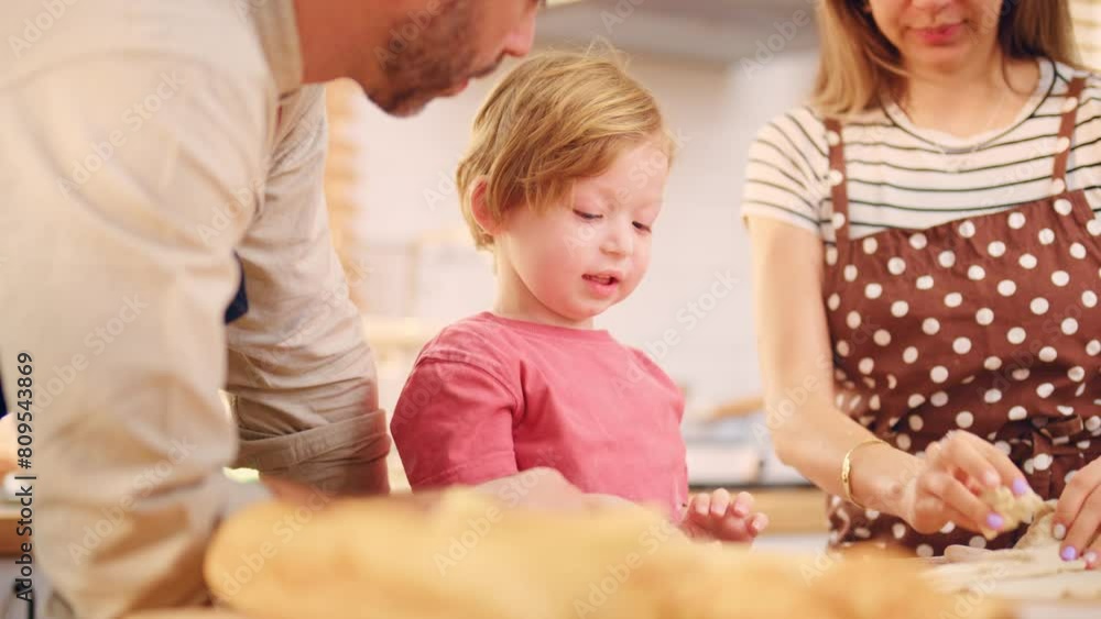 Caucasian attractive couple baking bakery with son in kitchen at home. Caucasian attractive couple baking bakery with son in kitchen at home.