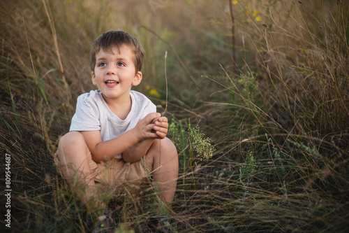 Photography Boy 3 years old against the backdrop of the steppe at sunset, close-up portrait