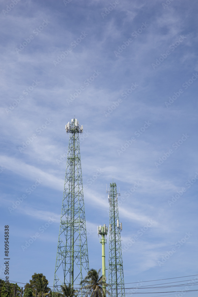 Green cell phone tower with blue sky background Green cell phone tower with blue sky background