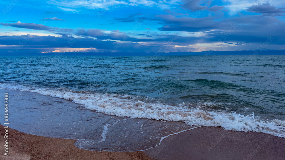 Fototapeta premium Big waves. stormy sea, thunderclouds. Kyrgyzstan, Lake Issyk-Kul