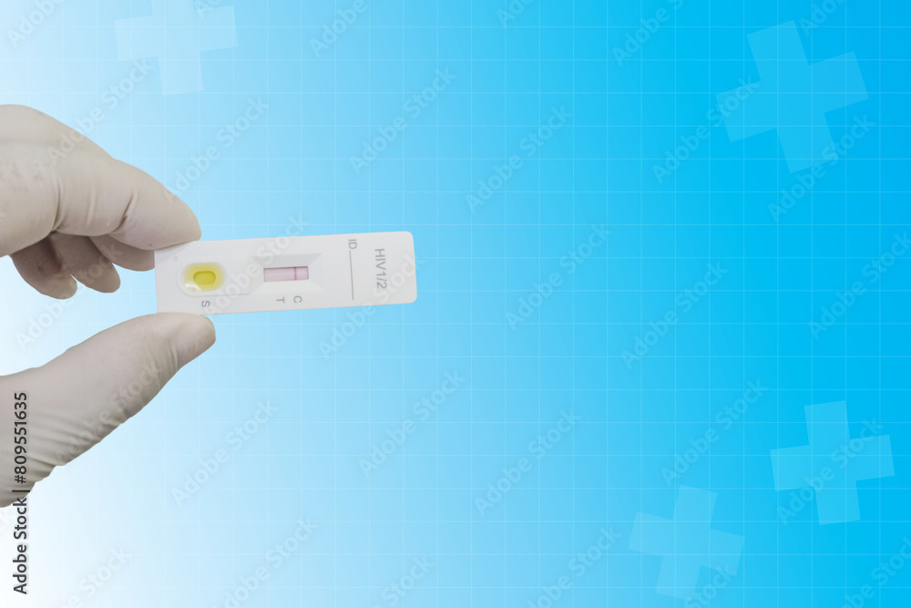 Doctor's hands wearing gloves and holding hiv test strips, hiv test kit, Dengue combo test strip, Dengue combo test kit in the laboratory. Health service and medical technology concept. Doctor's hands wearing gloves and holding hiv test strips, hiv test kit, Dengue combo test strip, Dengue combo test kit in the laboratory. Health service and medical technology concept.