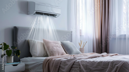 An air conditioner installed on the wall provides warm and cold air in a cozy bedroom filled with natural light photo
