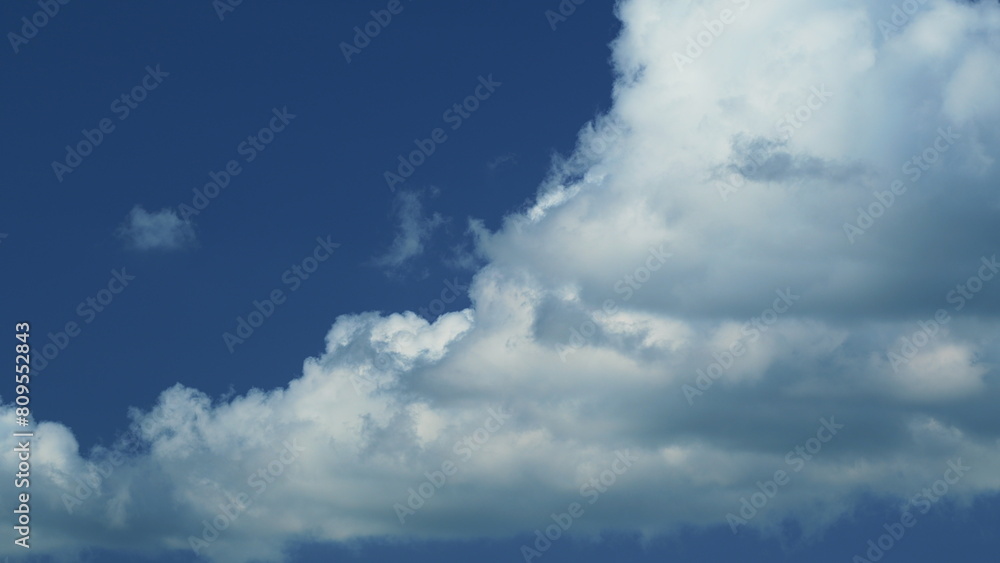 Puffy Fluffy White Clouds. Cumulus Cloud Cloudscape. White Fluffy Clouds Slowly Float Through Blue Daytime Sky.