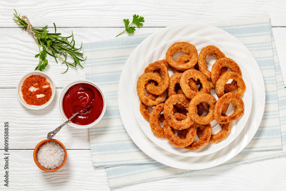deep fried crispy onion rings on white plate deep fried crispy onion rings on white plate