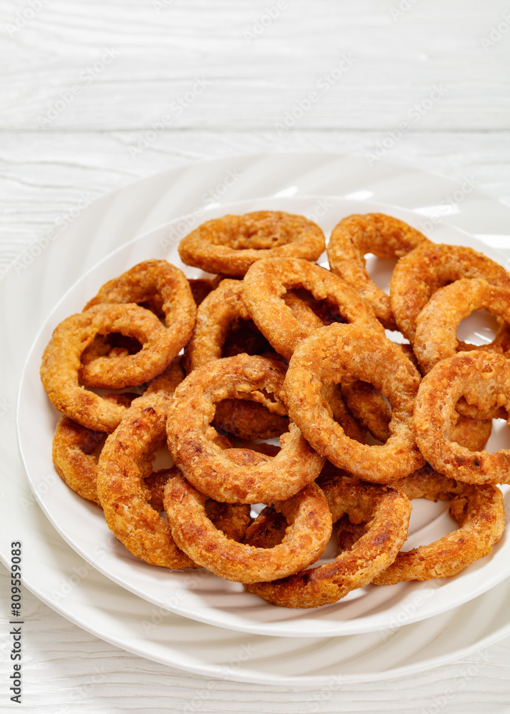 deep fried crispy onion rings on white plate deep fried crispy onion rings on white plate