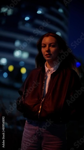 Wallpaper Mural Young woman in urban night setting, contemplative mood with blurred city lights Torontodigital.ca