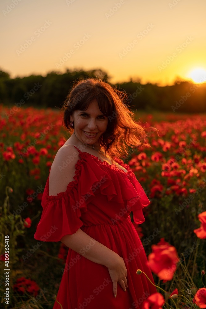 Woman poppy field red dress sunset. Happy woman in a long red dress in a beautiful large poppy field. Blond stands with her back posing on a large field of red poppies Woman poppy field red dress sunset. Happy woman in a long red dress in a beautiful large poppy field. Blond stands with her back posing on a large field of red poppies
