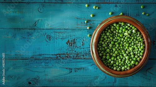 Pea seeds immersed in water in a clay container against a blue wooden backdrop ideal for wallpaper purposes photo