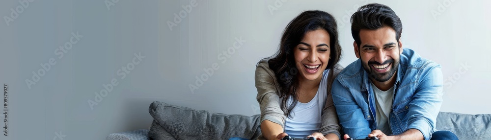 The couple is happy and having fun playing video games together, Indian and Asian in their mid-age The couple is happy and having fun playing video games together, Indian and Asian in their mid-age