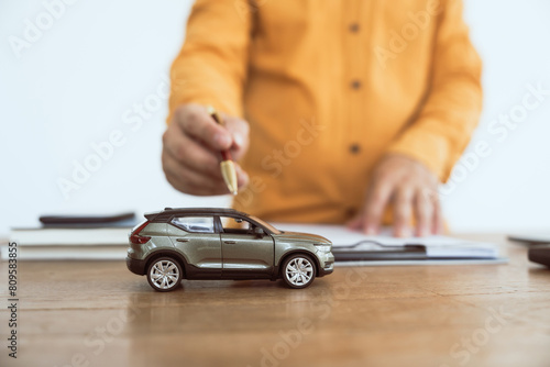 Close up businessman in formal dress working at desk. Automobile agreement insurance documents. Legal investment strategy for auto protection. Crash liability, expense, risk management for success.