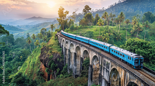 A blue train travels through the scenic mountains of Sri Lanka, crossing over the famous Nine Arch Bridge near Ella.