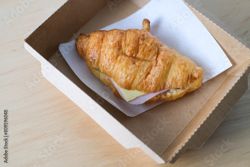 Ham cheese croissant in a box for breakfast.