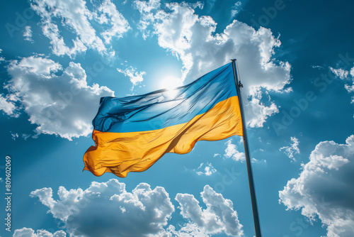 Vibrant Ukrainian flag waving against a sunny blue sky
